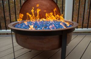 Natural Gas Fire Bowl with Blue Stones on a Deck