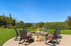 Chairs Next to a Backyard Fire Pit on a Patio